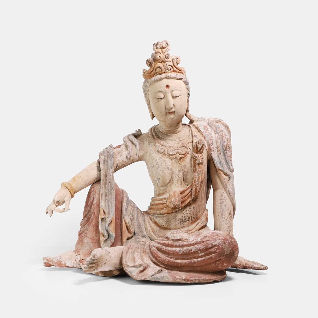 A Chinese polychrome painted carved wood figure, 20th century,: A Chinese polychrome painted carved wood figure, 20th century, of Guanyin seated in lalitasana with flowing robes 63cm high Footnote: 二十世纪 木&
