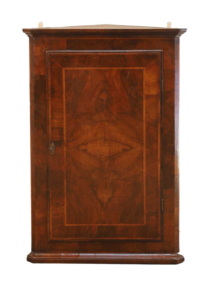 A George II walnut featherbanded corner cupboard, second quarter 18th century, (1 of 2)
