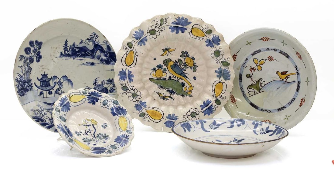 A group of four Delft pottery bowls, 17th century and later,: A group of four Delft pottery bowls, 17th century and later, comprising two Dutch lobed examples, each painted with stylised lemons, a blue and white bowl, with a stylised floral spray, a shallow bowl