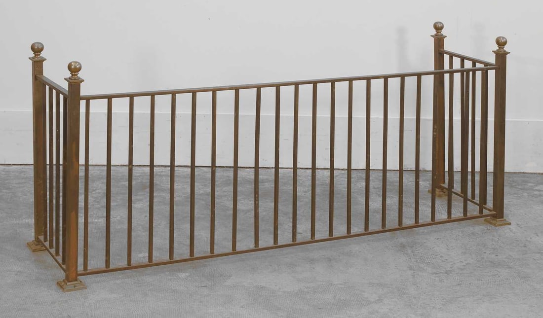 A low brass fire fender, 20th century,: A low brass fire fender, 20th century, with ball finials 145cm wide, 40cm deep, 65cm high