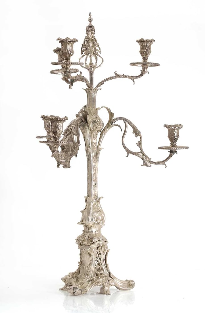 A silver-plated and white metal candelabra,: A silver-plated and white metal candelabra, the white metal central column, decorated with foliate motifs, is surrounded by six silver plated branches 45cm wide, 73.5cm high Condition Report: Branches