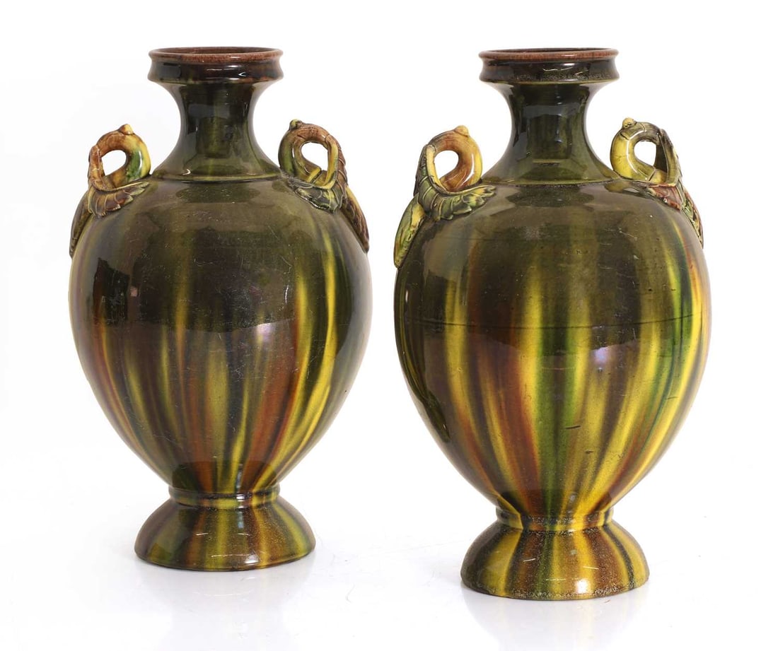 A pair of pottery vases, possibly Burmantofts, circa 1890,: A pair of pottery vases, possibly Burmantofts, circa 1890, with a streaked green over yellow glaze, wuth stylised handles, unmarked 24.5cm high 2 Condition Report: Some crazing.
