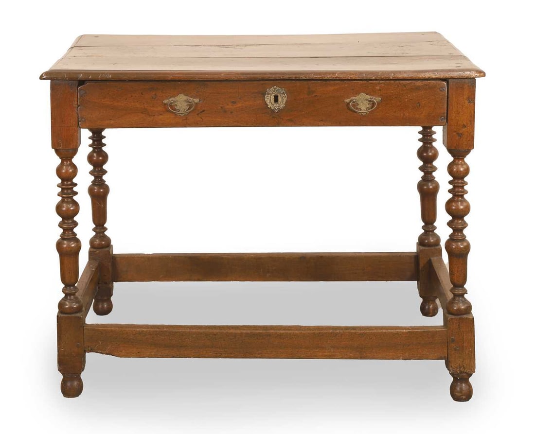 A walnut side table, 18th century, and later: A walnut side table, 18th century, and later with turned supports and single drawer 89cm wide, 58cm deep, 72cm high Condition Report: Historic woodworm and loss to the underside. A large dry crack thr