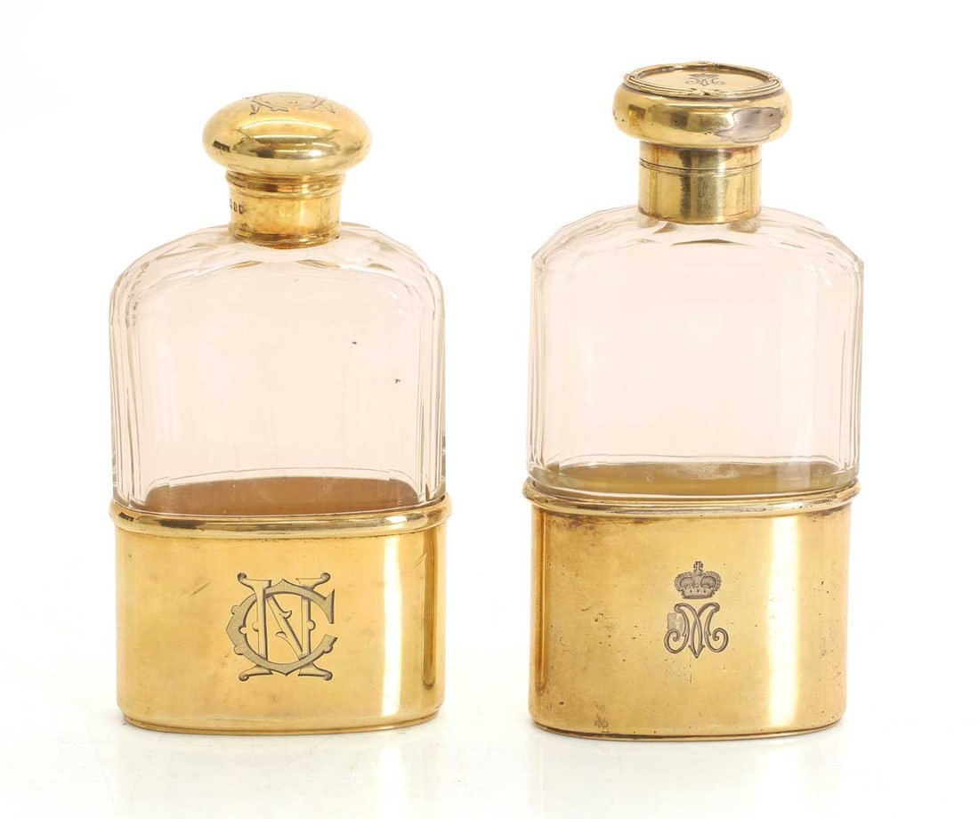A near pair of silver and clear glass hip flasks, with silver gilt mounts, - 2