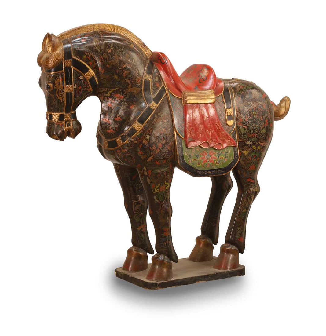 A large lacquered wooden horse, 20th century, Chinese,: A large lacquered wooden horse, 20th century, Chinese, with gilt detail, depicting, birds, floral arrangements and decorative motifs, 150cm wide, 127cm high, 40cm deep
