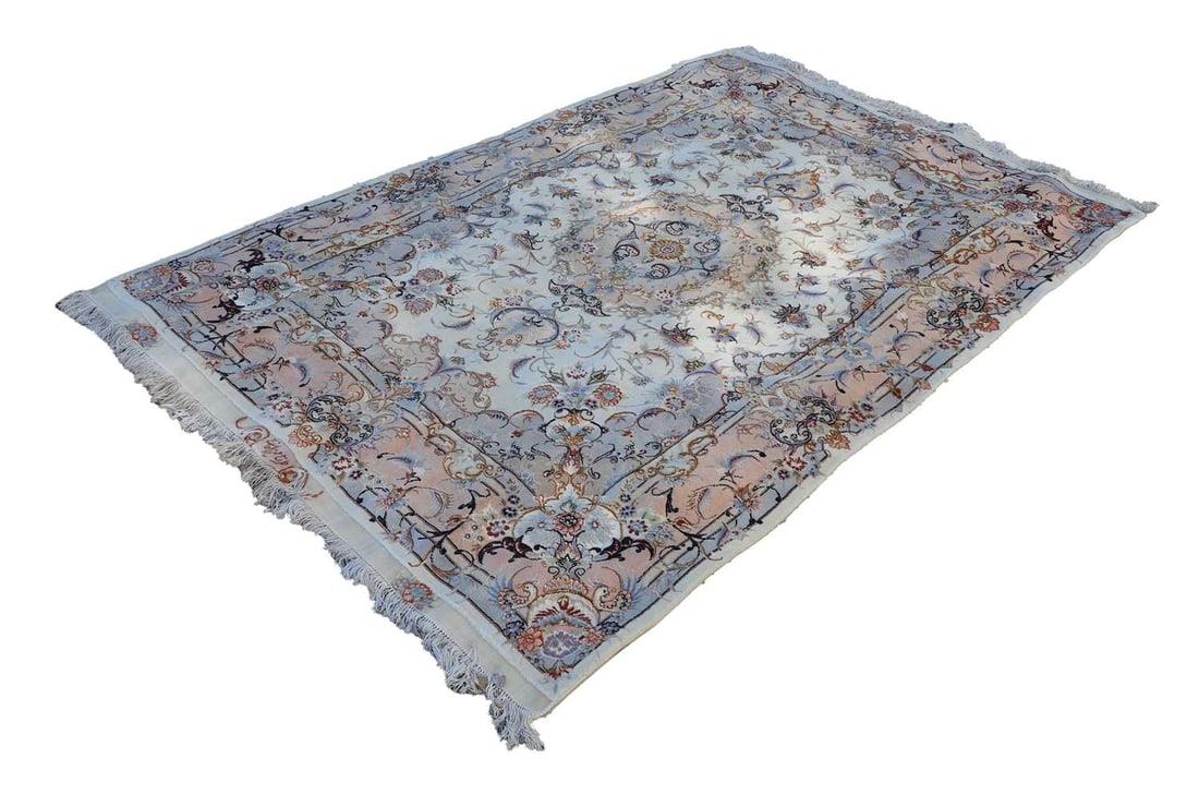 A silk Tabriz carpet: A silk Tabriz carpet possibly, Milza Karni, signed, the ivory ground with foliate and floral decoration 220 x 150cm