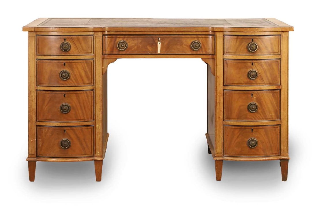 A mahogany pedestal desk, circa 1890,: A mahogany pedestal desk, circa 1890, with bow fronted banks of drawers, ebony line border inlays, and with black toiled leather top 122cm wide, 67cm deep, 72cm high Condition Report: Some staining