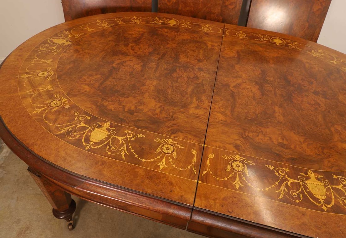 An inlaid walnut extending dining table, - 2
