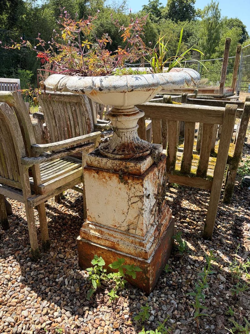 A large shallow cast iron urn, 19th century,: A large shallow cast iron urn, 19th century, painted white, with lobed edge, on square plinth base with moulded wreath, 104cm high 54cm wide Provenance: The contents of Thornton House, Clare.