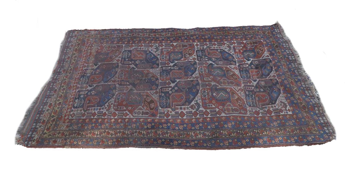 A Kamseh rug,: A Kamseh rug, on a red ground, with central field and repeating fifteen medallions, decorated with birds 199 x 118 Condition Report: Heavy repairs, areas of damage to borders