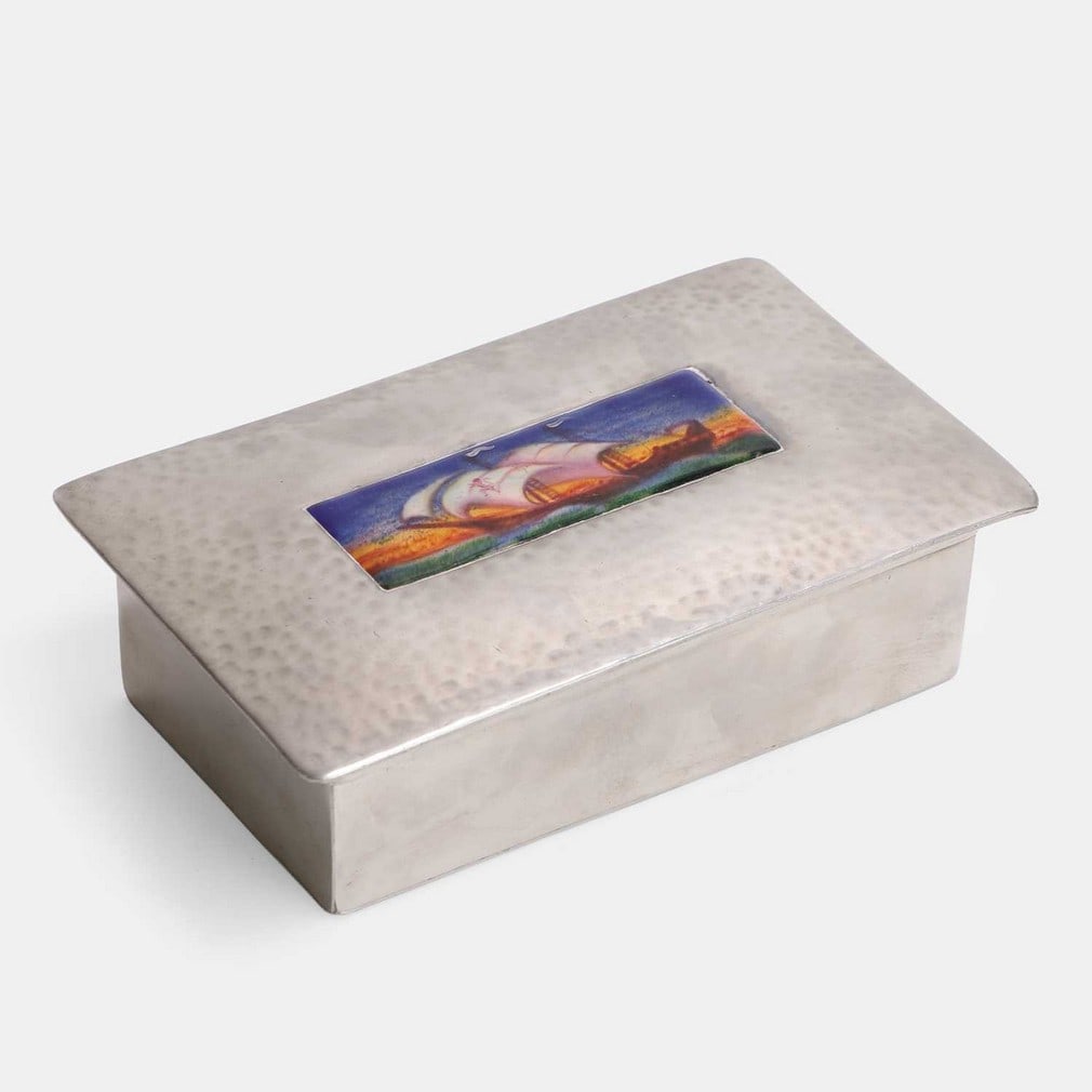 Liberty & Co., an Arts and Crafts trinket box,: Liberty & Co., an Arts and Crafts trinket box, no. 0125, pewter and enamelled, the hinged lid with an enamelled plaque of a masted galleon at sea, the design attributed to Charles Fleetwood Varley,