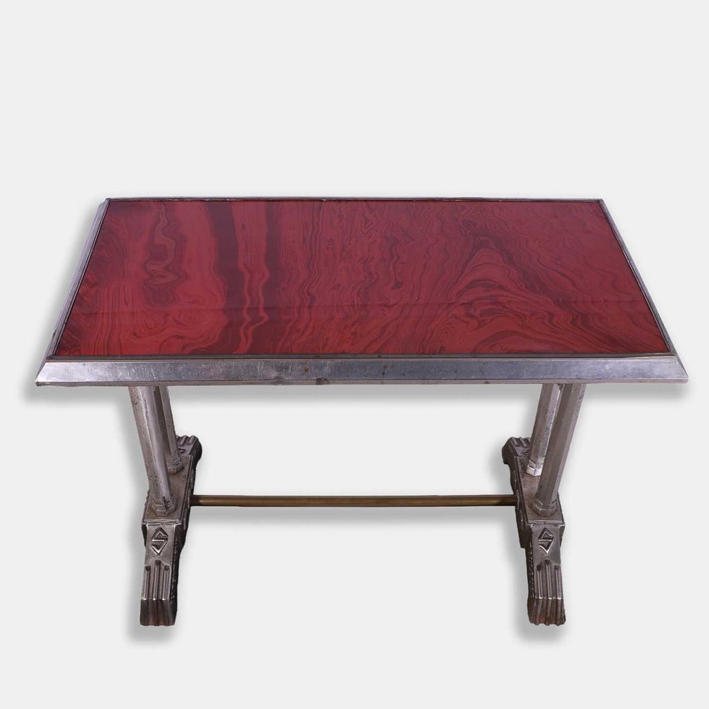 Sicre, a cast steel console table,: Sicre, a cast steel console table, circa 1920s, with a rectangular, polished-resin veined top, cast to the supports 'Au Pont Neuf Toulouse' (100cm wide, 50cm deep, 73cm high)
