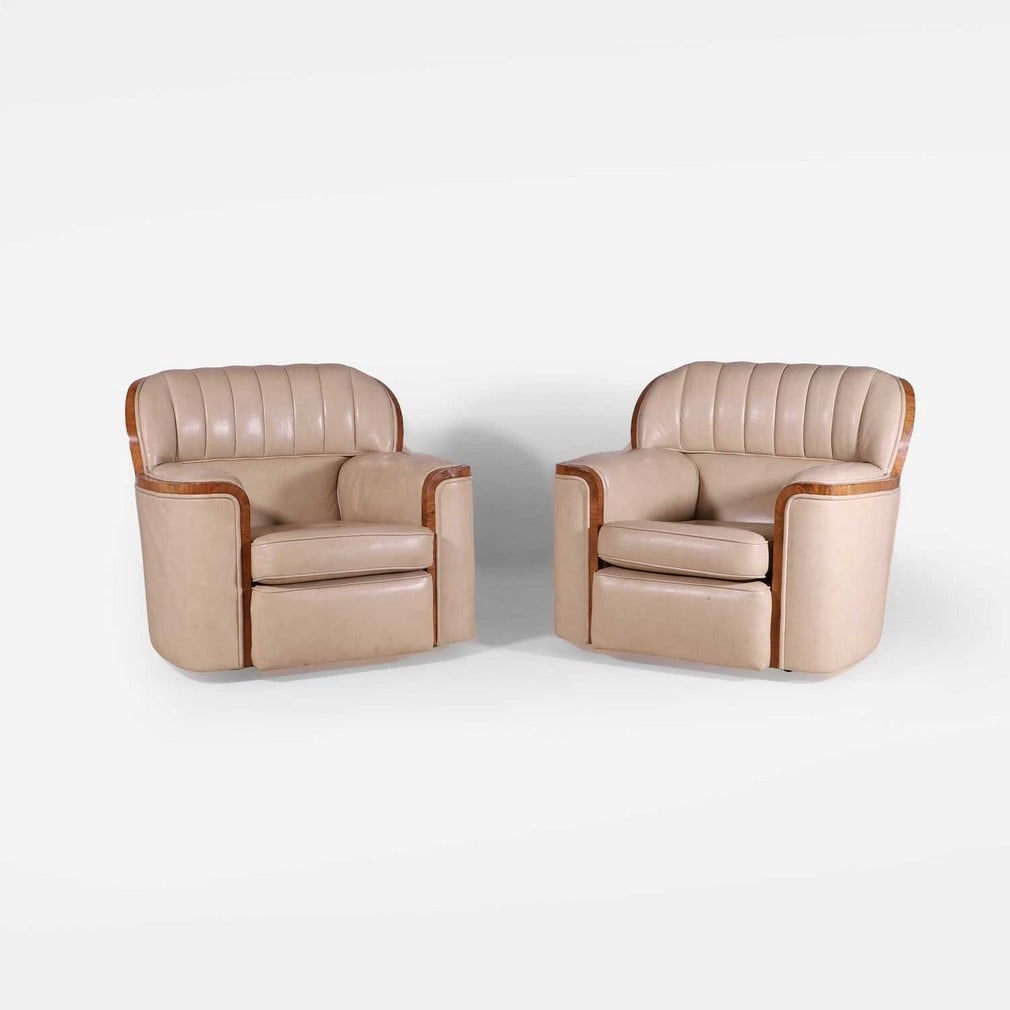 Attributed to Epstein Brothers, a pair of 'Bankers' armchairs,: Attributed to Epstein Brothers, a pair of 'Bankers' armchairs, circa 1930s, each with walnut-veneered details, upholstered in cream leather, raised on castors (94cm wide, 95cm deep, 80cm high, 41cm to