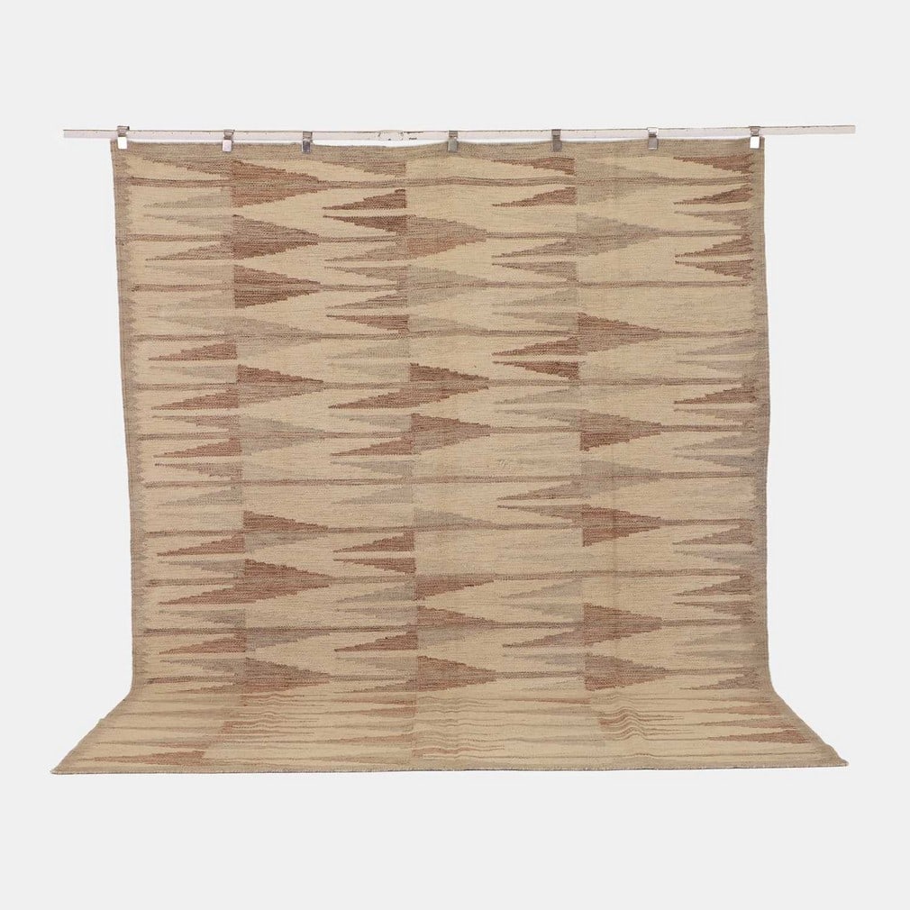 Mid-century Scandinavian-inspired, a flat-weave wool kilim,: Mid-century Scandinavian-inspired, a flat-weave wool kilim, of recent manufacture, woven in repeating geometric motifs in tones of brown and grey to a cream ground (303 x 242cm) Condition Report: Over