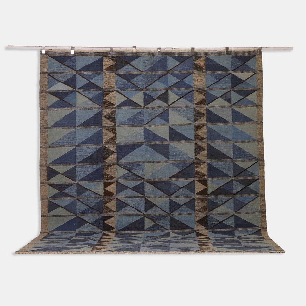 Mid-century Scandinavian-inspired, a flat-weave wool kilim,: Mid-century Scandinavian-inspired, a flat-weave wool kilim, of recent manufacture, woven with geometric motifs in tones of blue, grey and cream (303 x 254cm)