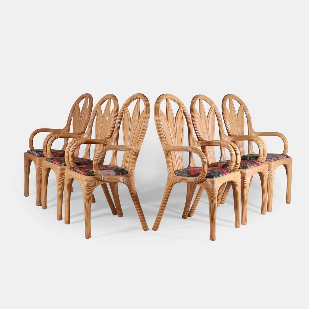 Vivai Del Sud, a set of six dining chairs,: Vivai Del Sud, a set of six dining chairs, circa 1970s, Italian, pencil reed rattan, each back modelled as a palm leaf, with rounded arms, raised on four legs, and with an upholstered seat pad in a