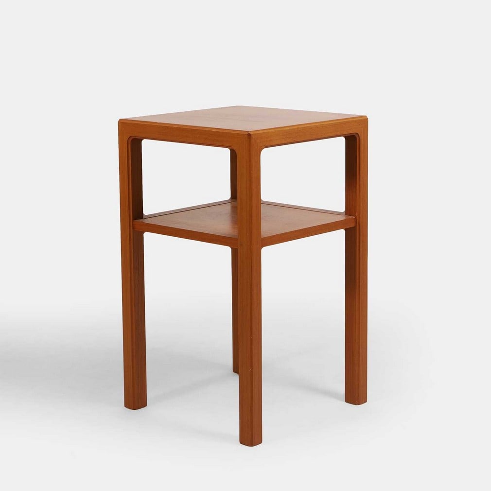 Kenmochi Design Associates for Tendo Mokko, a teak service table,: Kenmochi Design Associates for Tendo Mokko, a teak service table, 1970s, of square form, with a two-tier construction, raised on four square legs, with applied manufacturer's label (45.5cm wide,