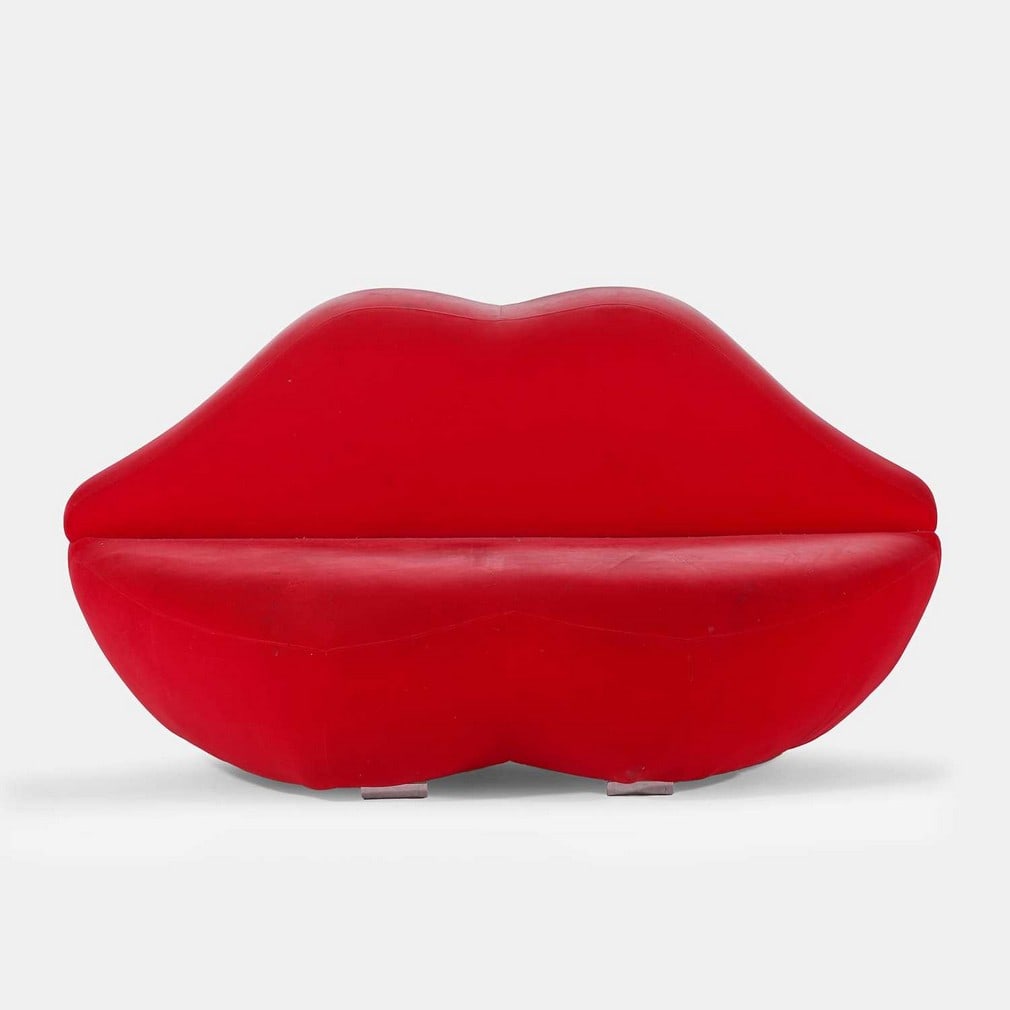 After Studio 65, a 'Bocca'-style sofa,: After Studio 65, a 'Bocca'-style sofa, originally designed in 1970 by Franco Audrito, modelled as a pair of lips, upholstered in red velvet, raised on four chromed metal cylinder feet (155cm wide, 78c