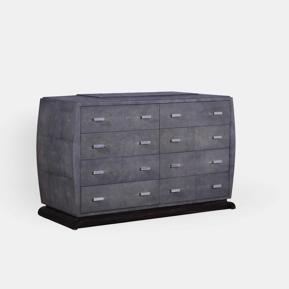 Contemporary, a grey faux shagreen chest of drawers,: Contemporary, a grey faux shagreen chest of drawers, of recent manufacture, the chest with eight drawers with polished-metal trapezoid-form handles, bowed sides and a stepped top, raised on a wood bas