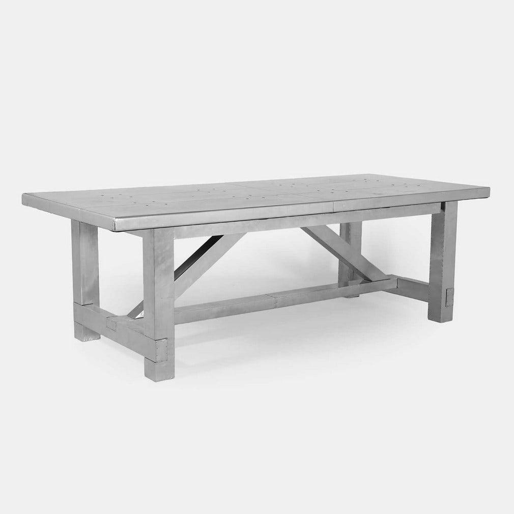 Timothy Oulton (British, 1967-2022), a 'Boston' dining table,: Timothy Oulton (British, 1967-2022), a 'Boston' dining table, of recent manufacture, distressed aluminium, the rectangular top over four block legs and angled supports, united by a stretcher (240cm wi
