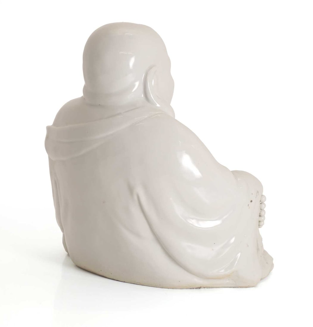 A Chinese blanc de chine porcelain figure of a Budai, - 2