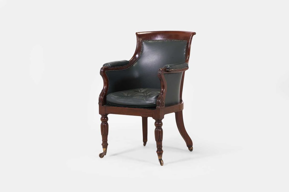 A George IV mahogany library bergère armchair, circa 1830, (1 of 3)