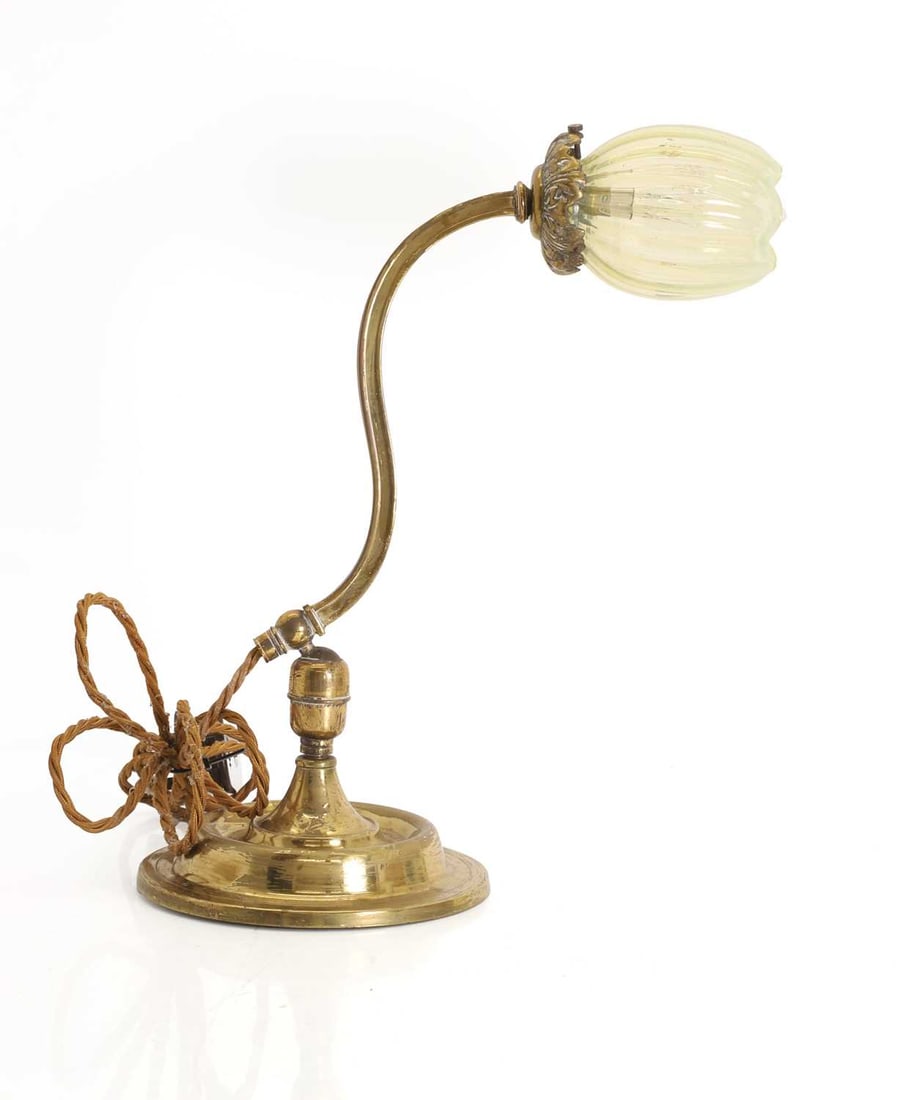 An Arts and Crafts brass table lamp, circa 1900,: An Arts and Crafts brass table lamp, circa 1900, with a ribbed opalescent glass shade, in the manner of James Powell & Sons 31cm wide, 36cm high