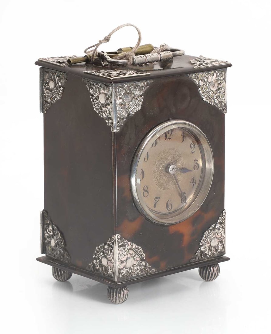 A small tortoiseshell and silver mounted carriage clock,: A small tortoiseshell and silver mounted carriage clock, the top with inlaid inscription 'MARY JULY 25 1881', the silvered dial with Arabic chapter ring, the mounts tested as silver 9cm wide, 7.5cm