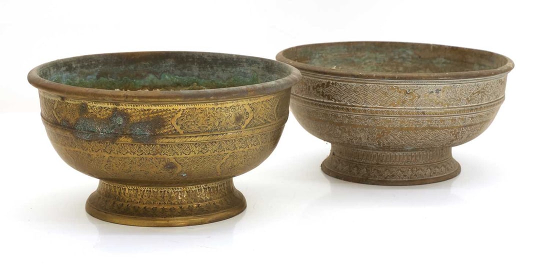 Two brass pedestal bowls, 19th-20th century, possibly Indonesian,: Two brass pedestal bowls, 19th-20th century, possibly Indonesian, each of circular form on a waisted foot, and cast with bands of geometric and foliate decoration largest 25cm diameter 2 Provenance: