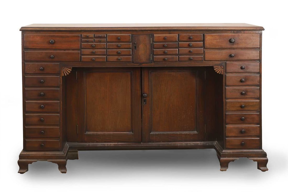 A Victorian mahogany side cabinet, late 19th century / early 20th century,: A Victorian mahogany side cabinet, late 19th century / early 20th century, the moulded top over an arrangement of miniature drawers, enclosing a pair of panelled cupboards, raised on ogee bracket feet