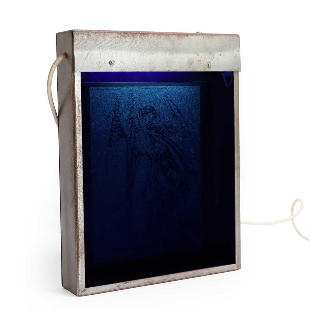 ▲ Mat Collishaw (British, b.1966) 'Ultra Violet Angel (No. 6)', 1993: ▲ Mat Collishaw (British, b.1966) 'Ultra Violet Angel (No. 6)', 1993 silkscreen with ultraviolet ink on paper, in a steel case illuminated by ultraviolet light, signed Mat Collishaw' on label ve