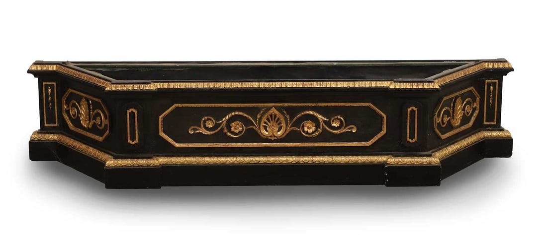 A Victorian ebonised and parcel gilt carved wood planter, mid to late 19th century,: A Victorian ebonised and parcel gilt carved wood planter, mid to late 19th century, with metal lining, the exterior decorated with relief floiate reserves 172cm wide, 40cm deep, 35cm high Condition