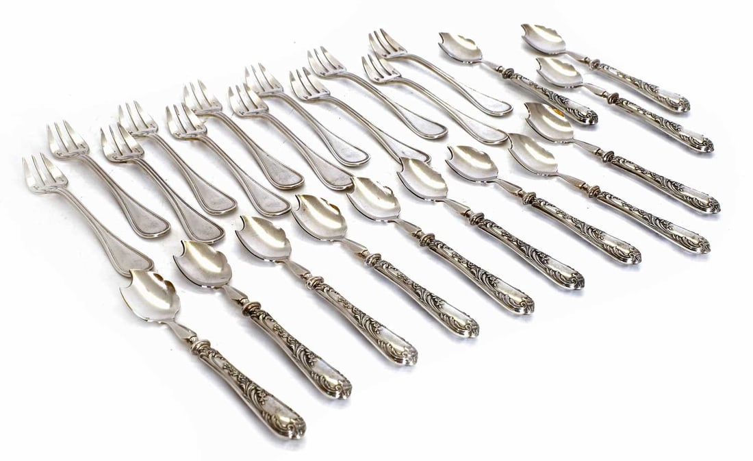 A Christofle oyster cutlery set,: A Christofle oyster cutlery set, to include twelve oyster forks in original box, together with a set of twelve French, 19th century bespoke oyster spoons with a bladed cutting edge, in original
