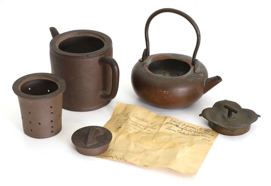 A Chinese Yixing zisha three piece teapot,: A Chinese Yixing zisha three piece teapot, with the seal marked to the base with purchase letters dating to 1866 from Nantucket 1886, together with a Japanese antique tetsubin, the lid shaped a