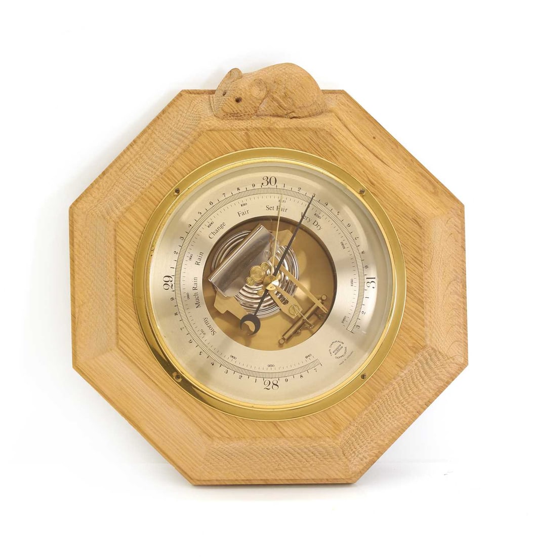 An oak framed barometer c.1970, by Robert Thompson, Kilburn: An oak framed barometer c.1970, by Robert Thompson, Kilburn carved with a signature mouse 22cm diameter