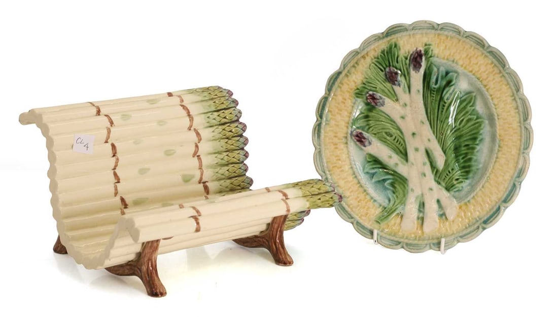 A Luneville Majolica asparagus bench, 19th century,: A Luneville Majolica asparagus bench, 19th century, shaped as a bunch of asparagus, together with a drainer plate with moulded baset weave rim Bench, 23.5cm wide, 21cm deep, 15.5cm high 2 Condition