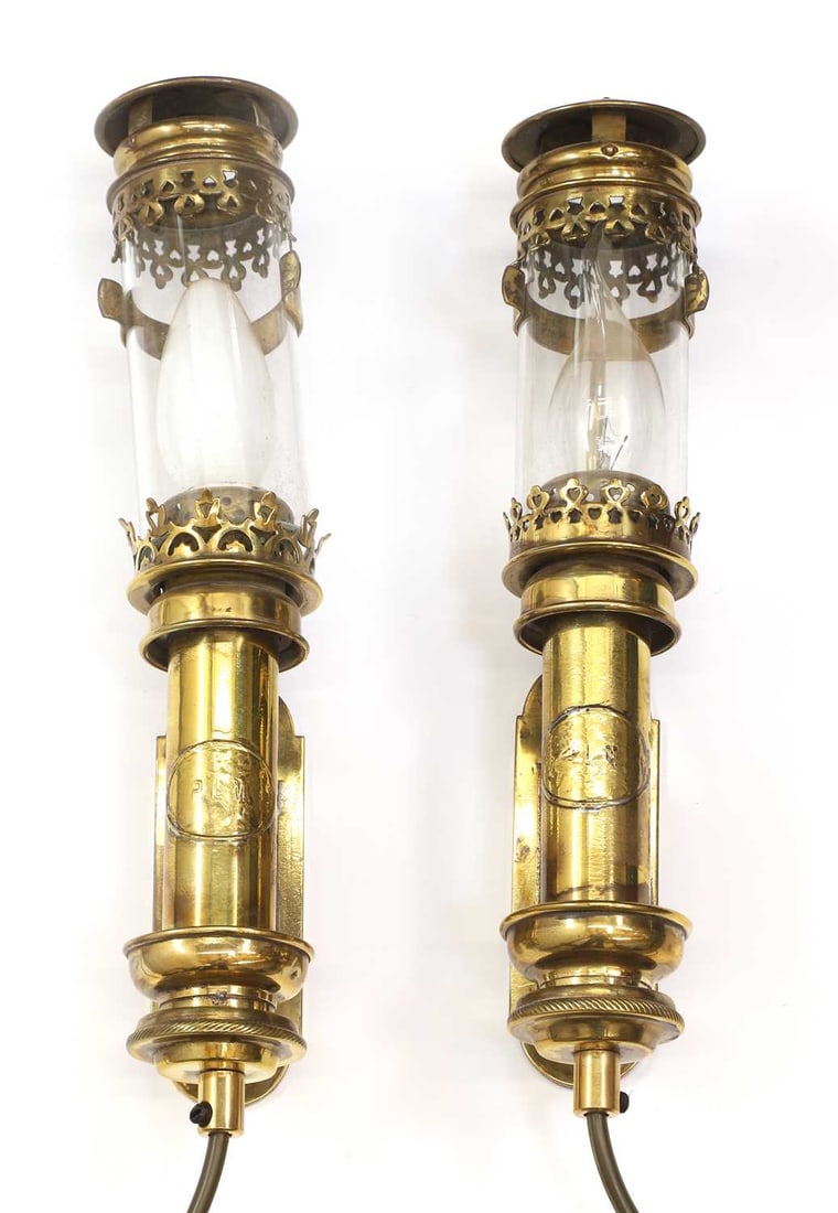 A pair of pullman carriage lamps, early 20th century,: A pair of pullman carriage lamps, early 20th century, with pierced brass detailing and cylindrical glass sahdes, converted to electric 32cm long 2 Condition Report: Some tarnishing to the surface and