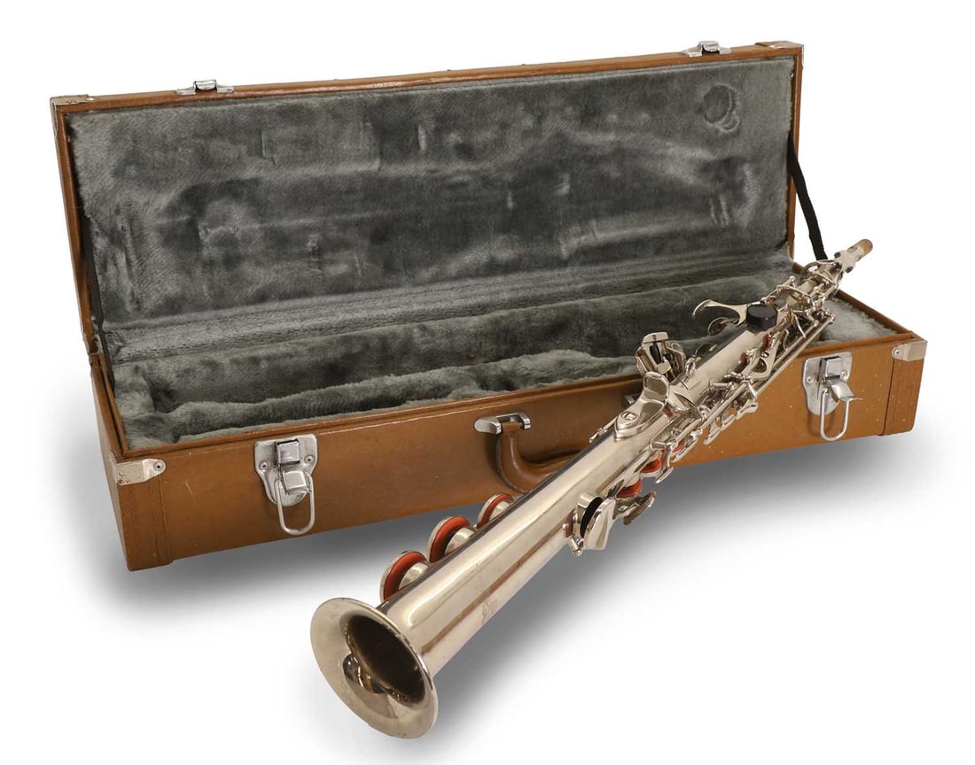 A straight soprano saxophone,: A straight soprano saxophone, engraved '13' to the body, with lustre inlay buttons 66cm long Condition Report: A collection of dust and dirt throughout. Some marks and scracthes to the surface. Duct