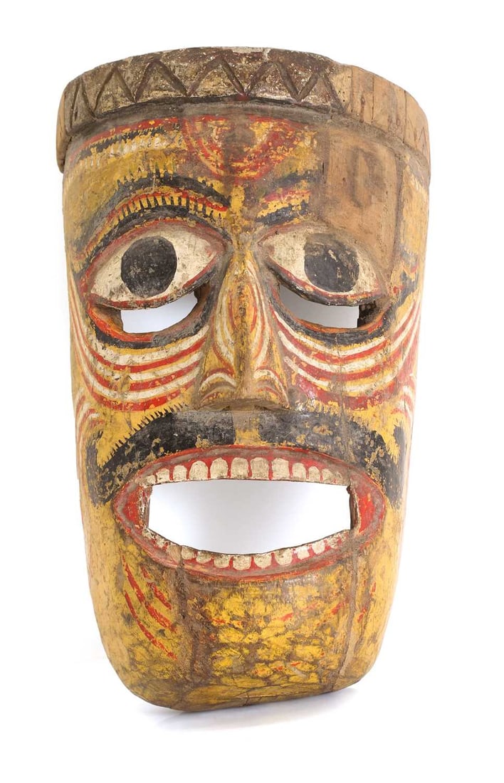 An Asian Nasik wooden carved mask, possibly Indian,: An Asian Nasik wooden carved mask, possibly Indian, polychrome painted with a yellow ground with bright eyes and open mouth 22cm wide, 33cm long Condition Report: Some chipping and flaking to the
