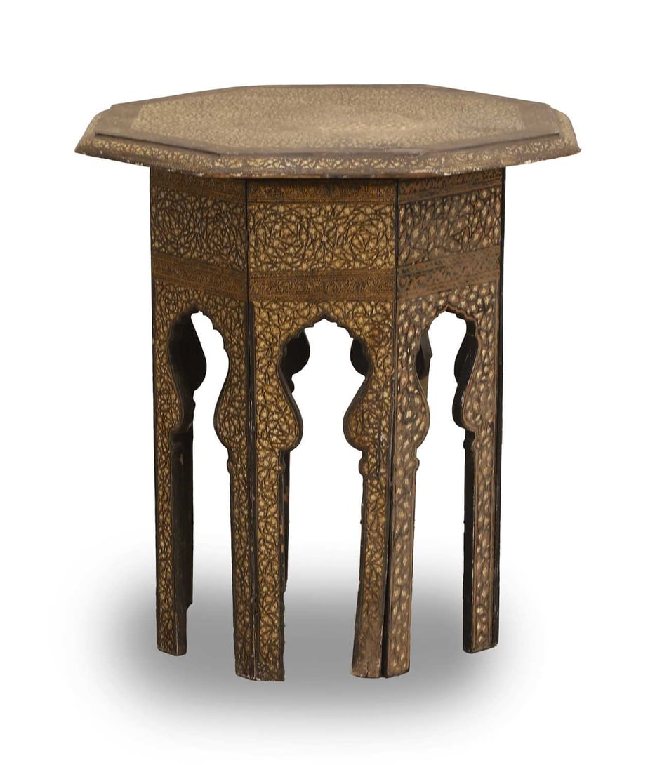 A Kashmiri Benares table,: A Kashmiri Benares table, of octagonal form with inlaid vine and floral details, and shaped arched base 44cm wide, 53cm high Condition Report: Paint flaking off on the underside and large repair and