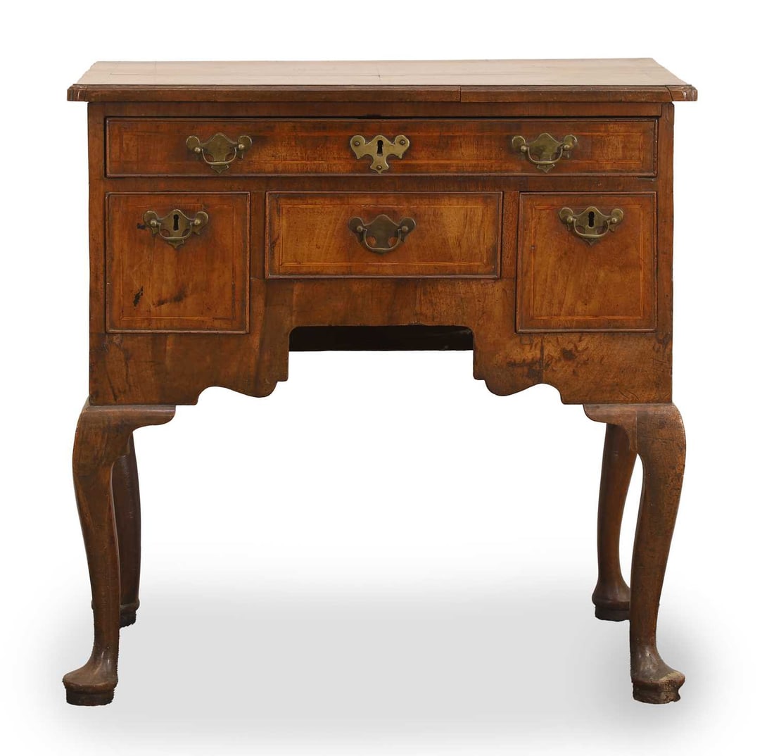 A walnut lowboy, early 18th century,: A walnut lowboy, early 18th century, fitted four drawers, with brass detailed escutcheons and pull handles, on cabriole legs 72.5cm wide, 45cm deep, 74cm high Condition Report: marks and knocks, a