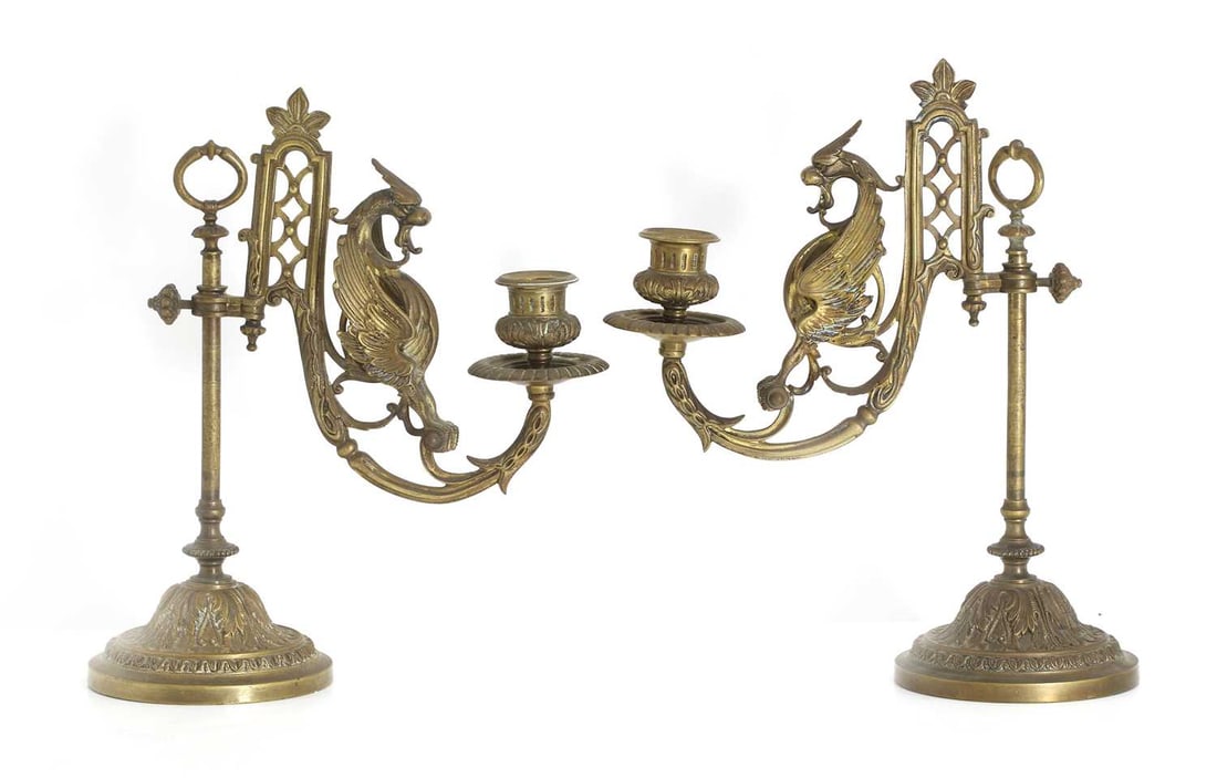 A pair of French bronze candelabra, 19th century,: A pair of French bronze candelabra, 19th century, featuring a winged mythical bird, on moulded circular bases 25cm wide, 28.5cm high 2
