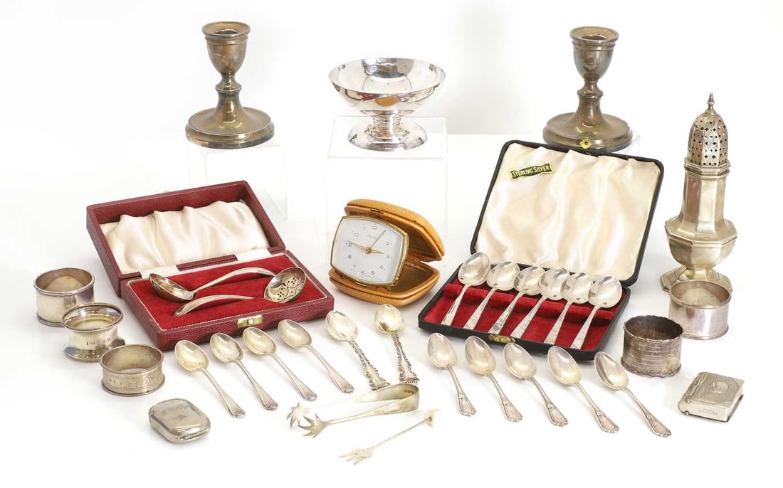 A collection of silver items,: A collection of silver items, to include, a sugar castor, Sheffield, Viner's Ltd (Emile Viner), a pair of dwarf candlesticks, filled, together with various flatware, including cased teaspoons, napkin