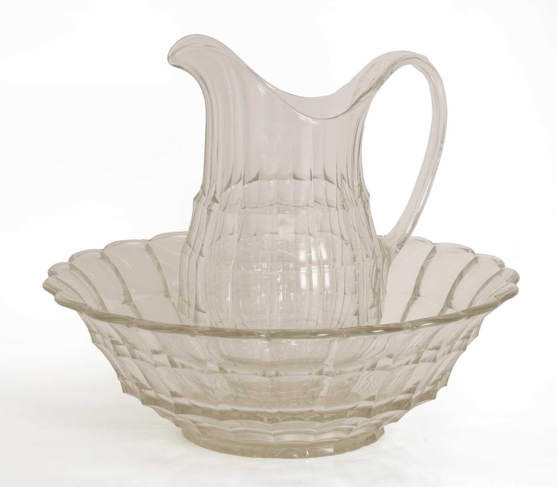 A Victorian moulded wash jug and basin,: A Victorian moulded wash jug and basin, moulded with faceted decoration Jug 32cm high, Basin 40cm diameter 2 Condition Report: Marks and collection of dust and dirt. The basin with glass fault