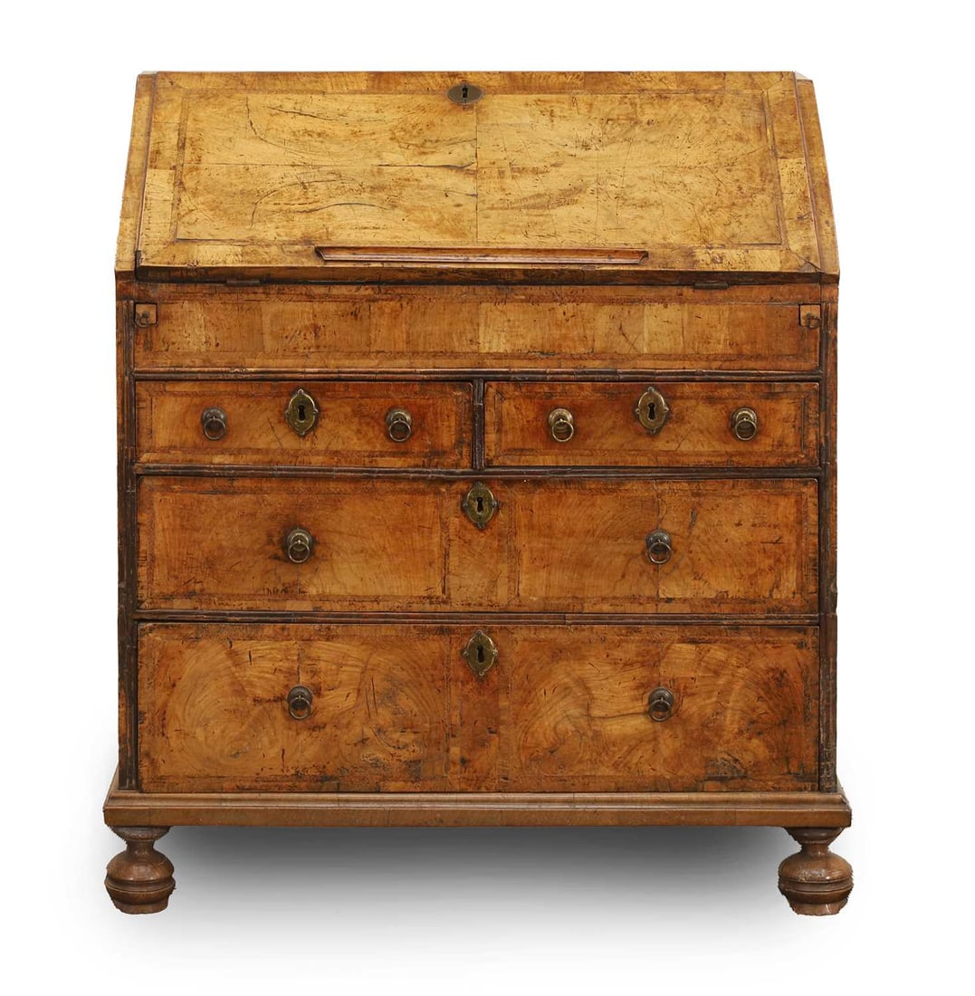 A Queen Anne walnut bureau, c.1710,: A Queen Anne walnut bureau, c.1710, with well compartment and stepped interior, the front flap with blue velet writing pad, with brass escutcheons and ring pull handles, 86cm wide, 49cm deep, 99cm