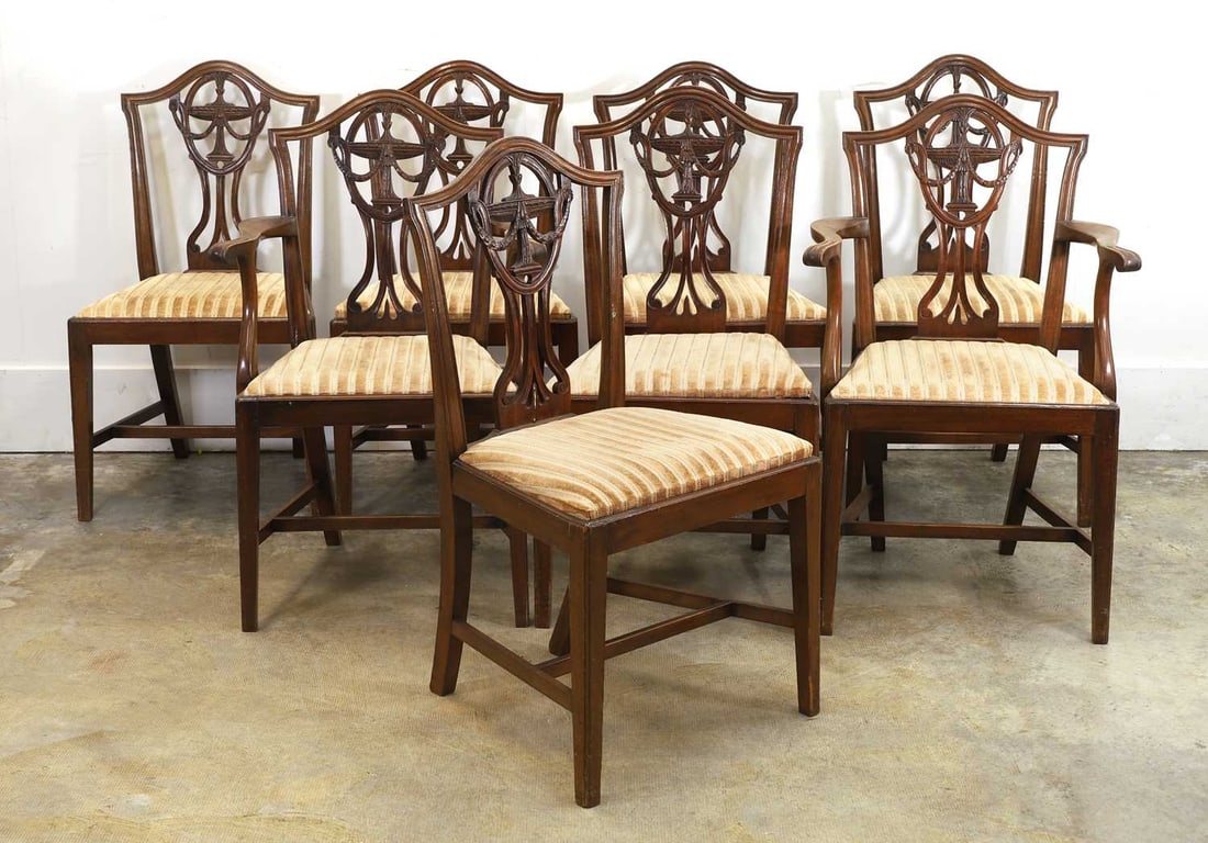 A set of six Hepplewhite mahogany dining chairs, circa 1800,: A set of six Hepplewhite mahogany dining chairs, circa 1800, with husk carved camel backs and drop-in needlework seats 53cm wide 44cm deep, 96cm high, 6