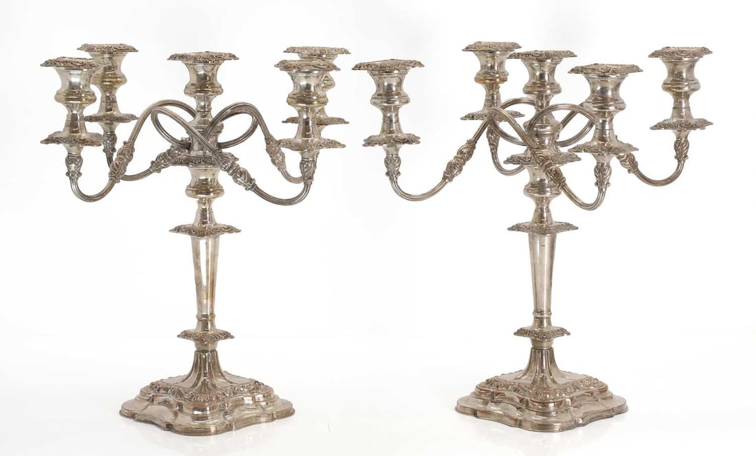 A pair of silver plated candelabra, late 19th / early 20th century,: A pair of silver plated candelabra, late 19th / early 20th century, with four reeded scroll branches each issuing a light, on shaped and moulded bases 37cm wide, 39cm high 2 Condition Report: