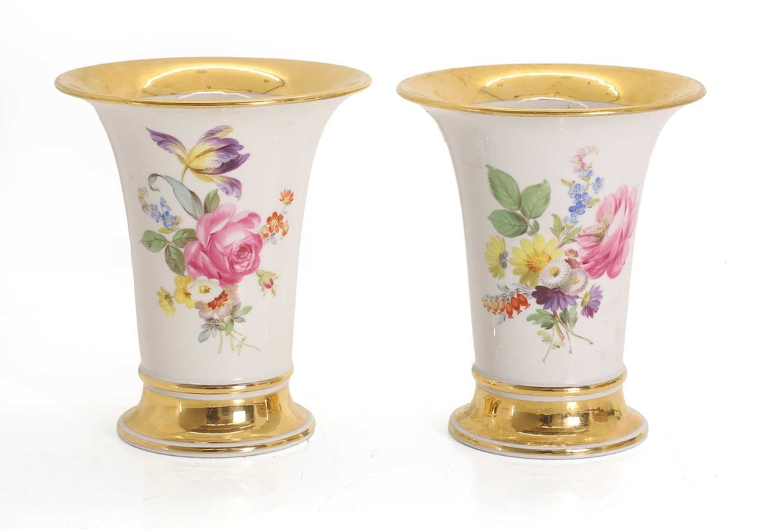 A pair of porcelain bud vases, late 19th / early 20th century,: A pair of porcelain bud vases, late 19th / early 20th century, foliate decoarated, heighted with gilding, bearing the cross swords in underglaze blue of Meissen 14cm wide, 16cm high 2 Condition