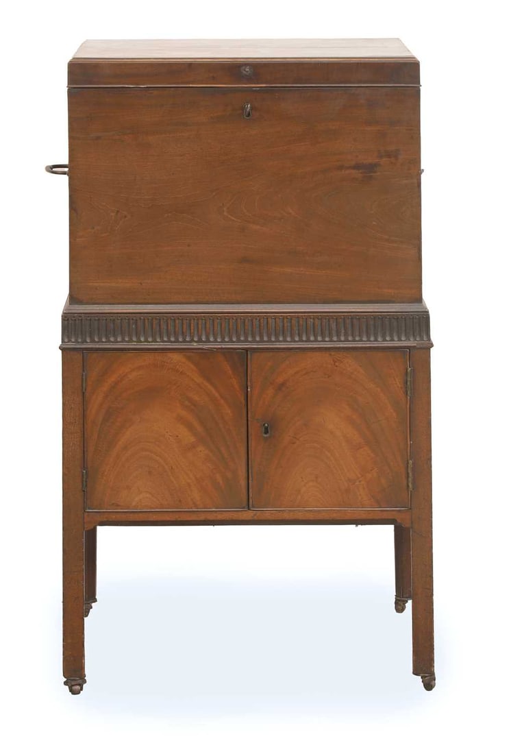 A Regency mahogany cellarette, c.1810: A Regency mahogany cellarette, c.1810 the lift top opening to reveal a fitted and sectioned interior and a cupboard base below 51cm wide, 39cm deep, 91cm high Condition Report: knocks and marks, key