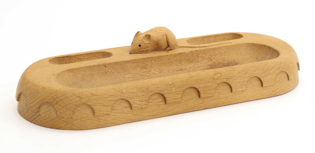 An oak pen tray, by Robert Thompson, Kilburn,: An oak pen tray, by Robert Thompson, Kilburn, of rectangular form with rounded ends and penny-moulding, three sections, with the carved mouse signature 30cm long, 11.5cm wide Condition Report: Some